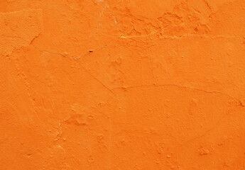 Abstract background of orange plaster on an old wall.