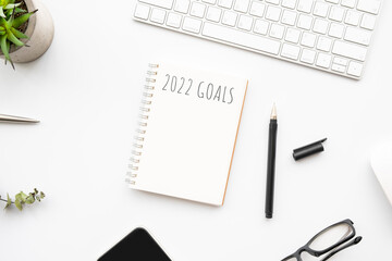 Notebook with 2022 goals text on it to apply new year resolutions and plan.