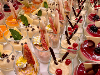 Close up of various colorful and delicious desserts in glass.