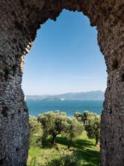 Lake Garda and Stone Arch of Grottoes of Catullus Roman Villa Ruins in Sirmione, Italy