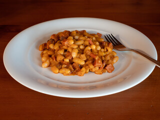 Bean Goulash or Wiener Bohnengulasch, a Viennes Stew from Vienna, Austria on a White Plate with Fork