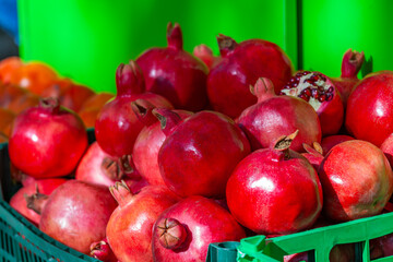 Ripe pomegranates on the market counter