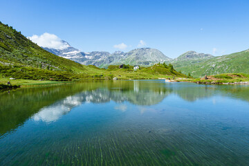 Fototapeta na wymiar The meadows, glaciers, lakes and mountains of the Simplon Pass: one of the most beautiful areas of Switzerland located in the heart of the Alps - July 2021.
