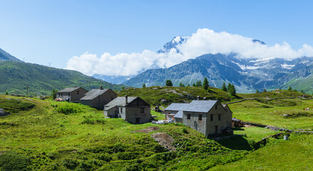 The mountain pastures and small villages among the meadows of the Simplon Pass (Switzerland),...