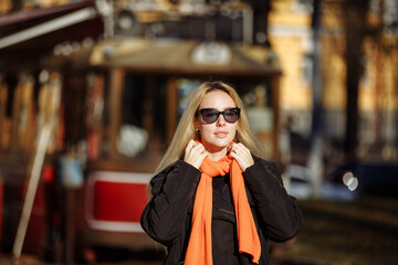 girl in black clothes with glasses on the background of the city