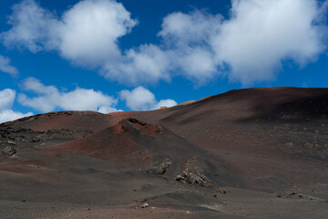 Tourist bus driving through the Fire Mountains in Timanfaya National Park. Unique volcanic formations in Lanzarote island - Canary Islands
