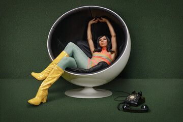 Young woman from the 60s sitting in a vintage ball chair, her rotary dial telephone off the hook at her feet - obrazy, fototapety, plakaty
