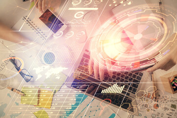 Double exposure of man's hands typing over computer keyboard and data theme hologram drawing. Top view. Technology concept.