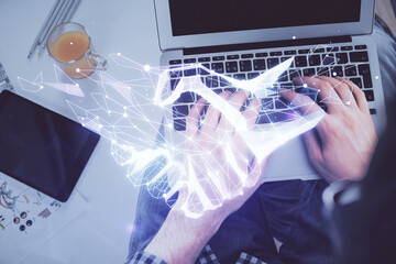 Double exposure of man's hands typing over computer keyboard and handshake drawing. Top view. Partnership concept.