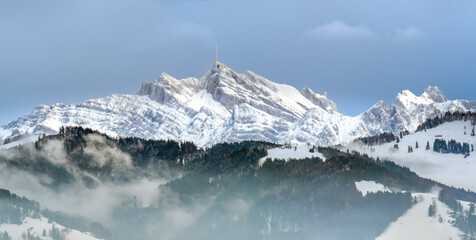 Stunning view of the famous Santis (Säntis) peak on a foggy winter day, eastern Switzerland