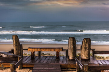 wooden bench facing the ocean