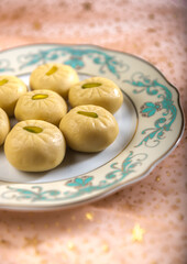 Close up of Pedha, a popular Indian sweet made with condensed milk. Selective focus treatment food photography.