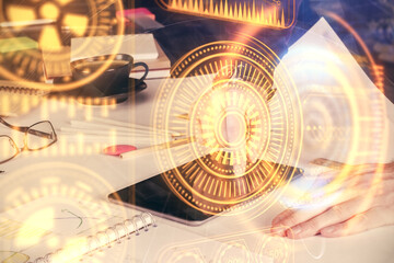 Double exposure of man's hands holding and using a digital device and tech theme hologram drawing. Technology concept.