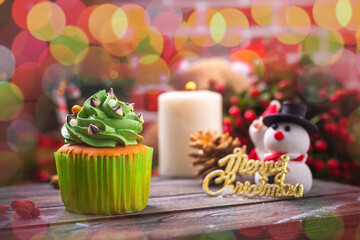 Christmas cupcakes with snowman and santa clause made from sugar on wooden table for celebrate in christmas and new year festival.