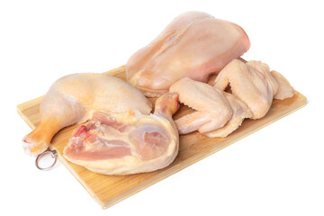 A chicken carcass cut into pieces on a cutting board, isolate on a white background. Legs, thighs, breast and wings of a chicken on a cutting board