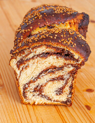 Cocoa and nuts sweet bread on wooden table, front view