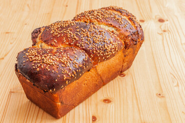 Cocoa and nuts sweet bread on wooden table, view from above