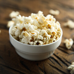 Homemade salted popcorn in a white bowl