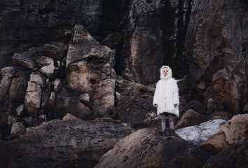 Obraz premium Fashion shooting in nature, a girl model in a fur coat made of artificial fur.