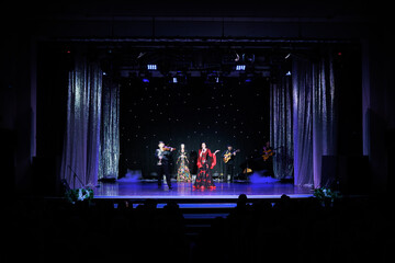 A team of musicians, singers and dancers in gypsy costumes singing and dancing on stage