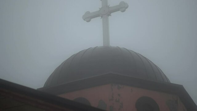 Cross of a orthodox church in foggy weather