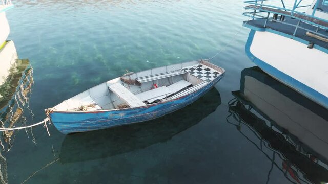 Small lonely wooden boat in the lake of Ohrid, Mecedonia. Ohrid lake is one of the oldest and deepest lakes in Europe.