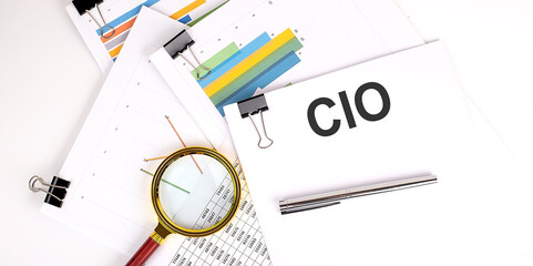 CIO Chief Information Officer , text on white paper on the light background with charts paper