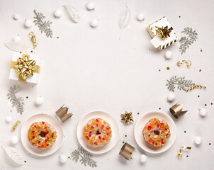 Fototapeta na wymiar Roscon de reyes, spanish three kings Christmas sweet cake with winter decorations on white background