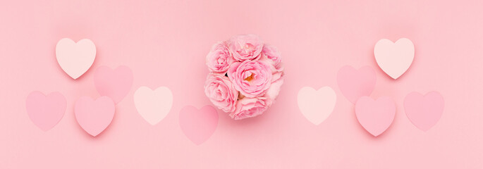 Flowers roses and  pink paper hearts on pink background. Valentines day concept. Flat lay, top view, copy space.