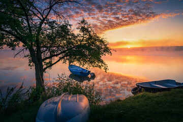 Boat on the lake in the rays of the rising sun and fog, zemborzycki lake © RafalDlugosz