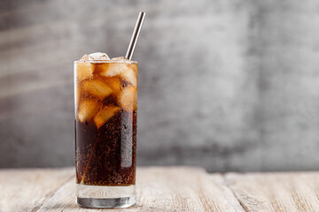 Cola with Ice Cubes. Glass of cola with ice cubes on wood table, soft drink. - obrazy, fototapety, plakaty
