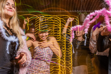 Friends dancing in nightclub with moving lights
