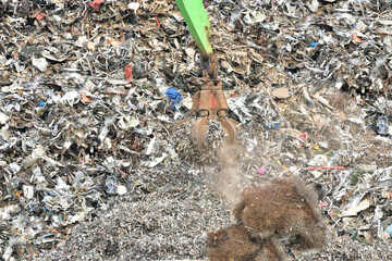 Machine operated grabbing arm, loading scrap metal onto a ship in the harbour of Newhaven, UK....