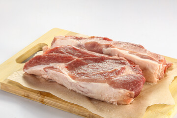 Raw pork fillet over board