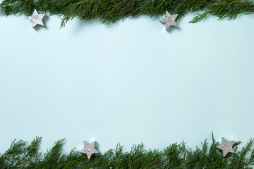 Obraz premium Christmas composition. Fir tree branches, decorations on blue background. Christmas, winter, new year concept. Flat lay, top view, copy space