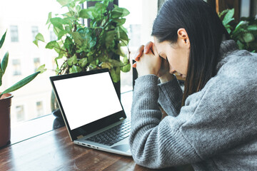 Exhausted caucasian student working on laptop, suffering from headache or migraine. Tired male...