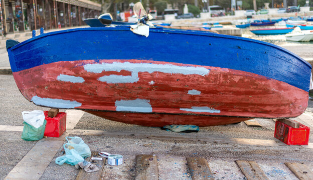 fisherman boat being repaired on the seaport before starting a new outing at sea