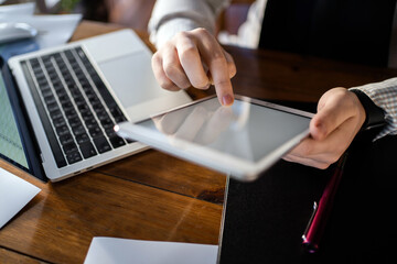 Considers finance expenses in a new startup. Workplace at home. A man makes a report to the company. Surf the Internet.