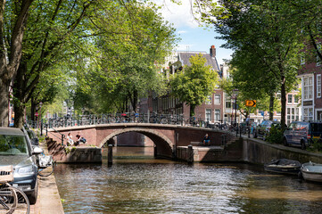 street view with buildings, greenery, sky and canals