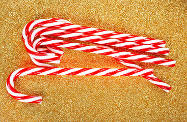 Candy canes on gold background. Christmas decoration