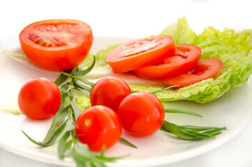 Tomatoes and salad leaves on the plate