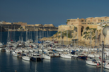 Fototapeta na wymiar Bay with marina and boats during clear day on island of Malta