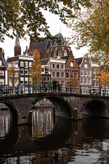 Fototapeta na wymiar Street view with buildings and during day and canal in Amsterdam, Netherlands