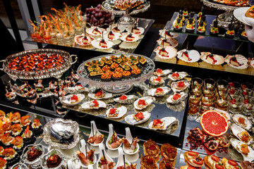 Banquet Meat Bar. Cold snacks with vegetables, fish and rucola on bread, canapes