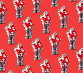 Pattern made of Santa holding gift box against red background. Minimal Christmas concept. Creative pattern idea.