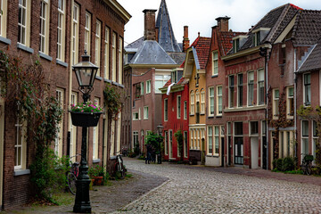Fototapeta na wymiar Beautiful and quaint street view with old buildings and greenery in spring in Leiden, Netherlands