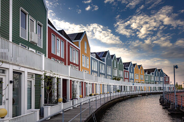 Colorful houses at sunset by the water in Houten, Netherlands