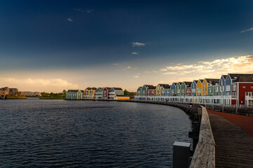 Fototapeta premium Colorful houses at sunset by the water in Houten, Netherlands