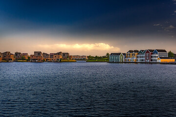 Colorful houses at sunset by the water in Houten, Netherlands