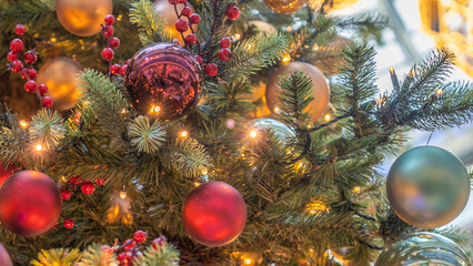 Obraz na płótnie Canvas Traditional artificial Christmas tree with Christmas toy, ball and glowing colorful lights in background. Xmas concepts.